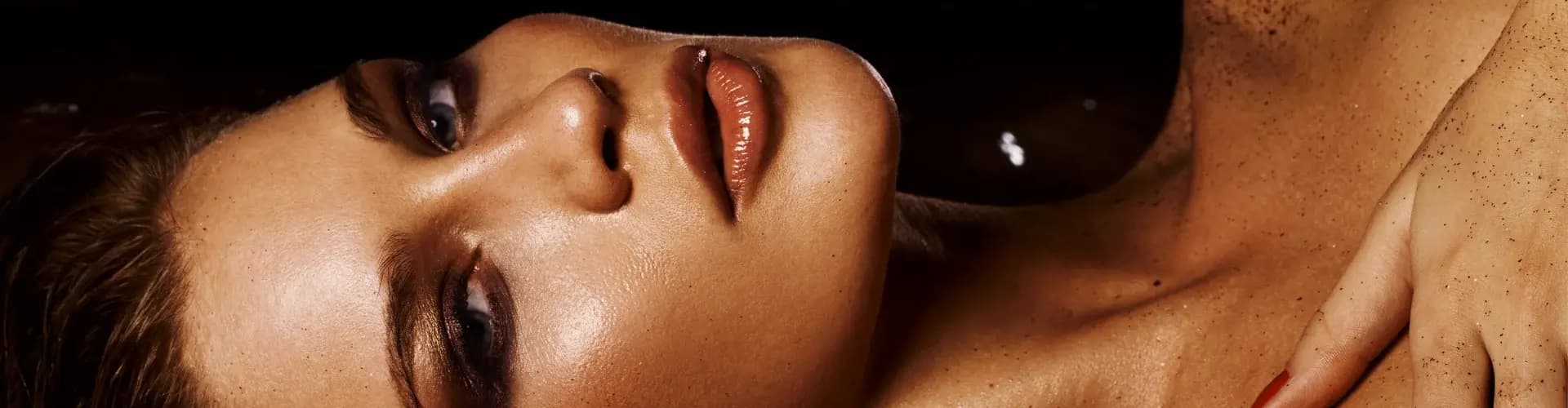 A close up of a woman laying on her back.