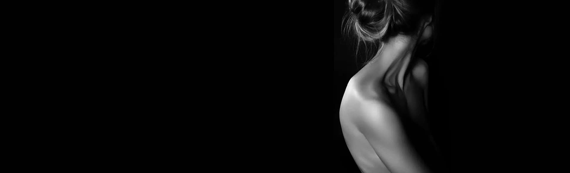 A black and white photo of a woman's back showcasing the impressive transformation through Bodytite Before and After Photos.
