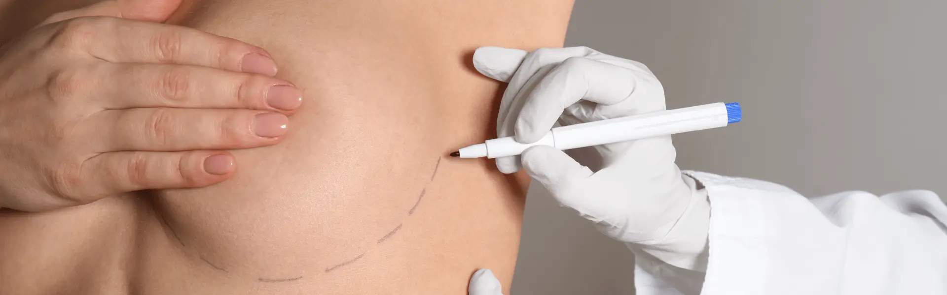 A woman is getting a tattoo on her stomach.
