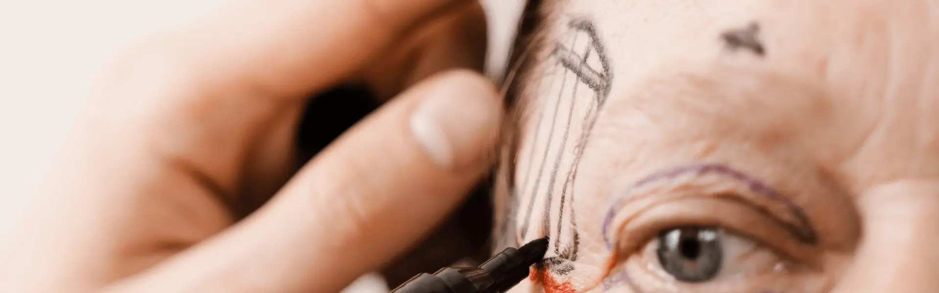 A woman's eye is being drawn with a pencil.