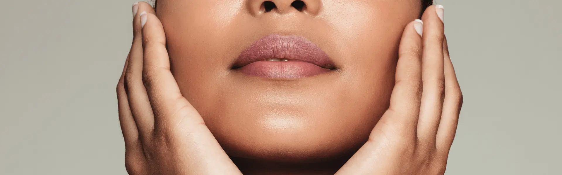 A woman with her hands on her face.