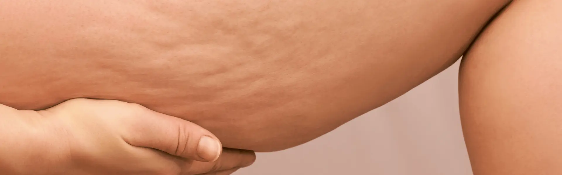 A woman is touching her stomach with her hand.