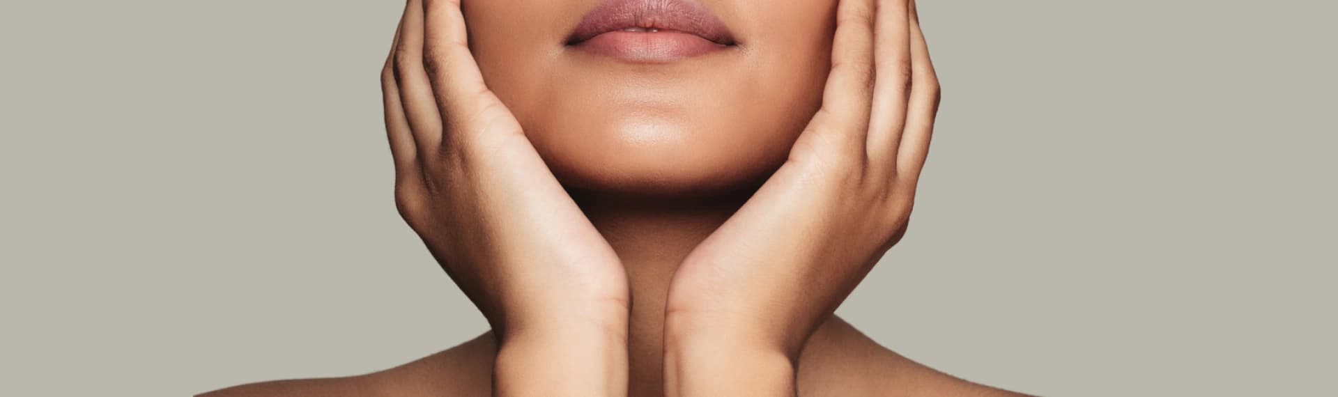 A woman with her hands covering her face.