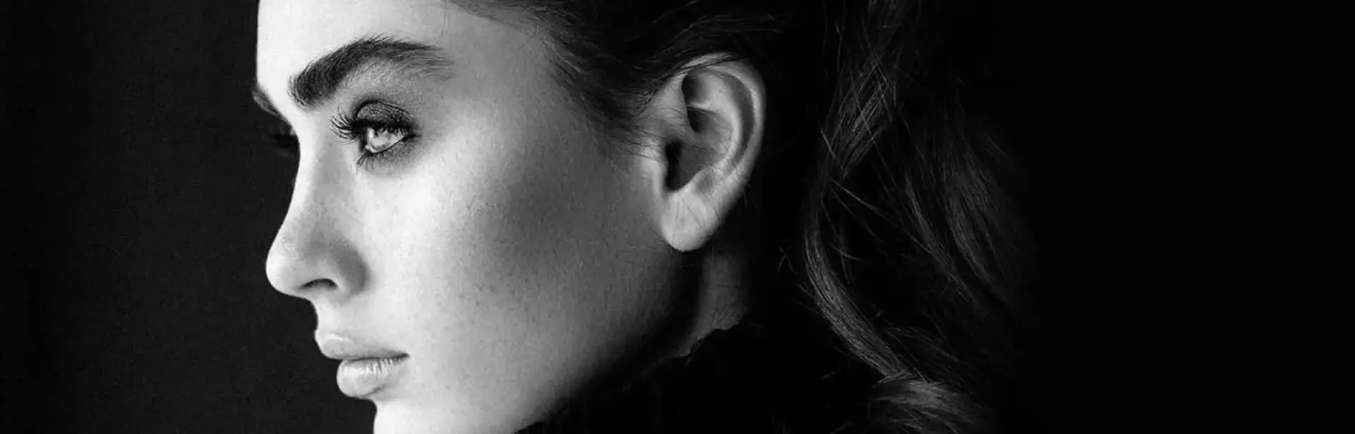 A black and white photo of a woman's face.