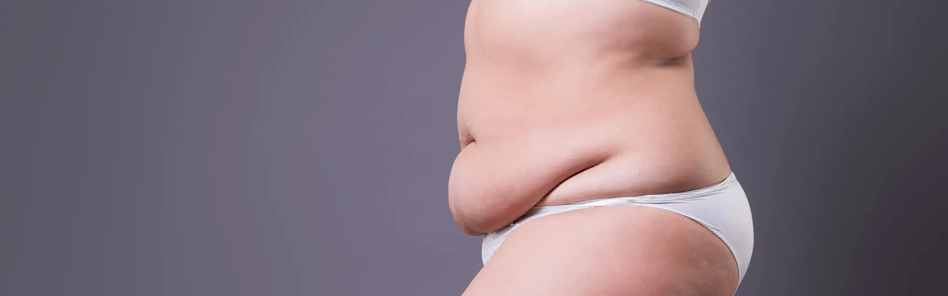 A woman in a bikini showing her stomach.