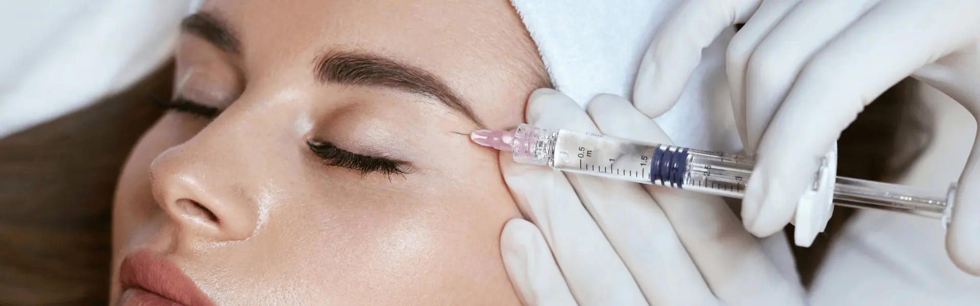 A woman getting an injection in a beauty salon.