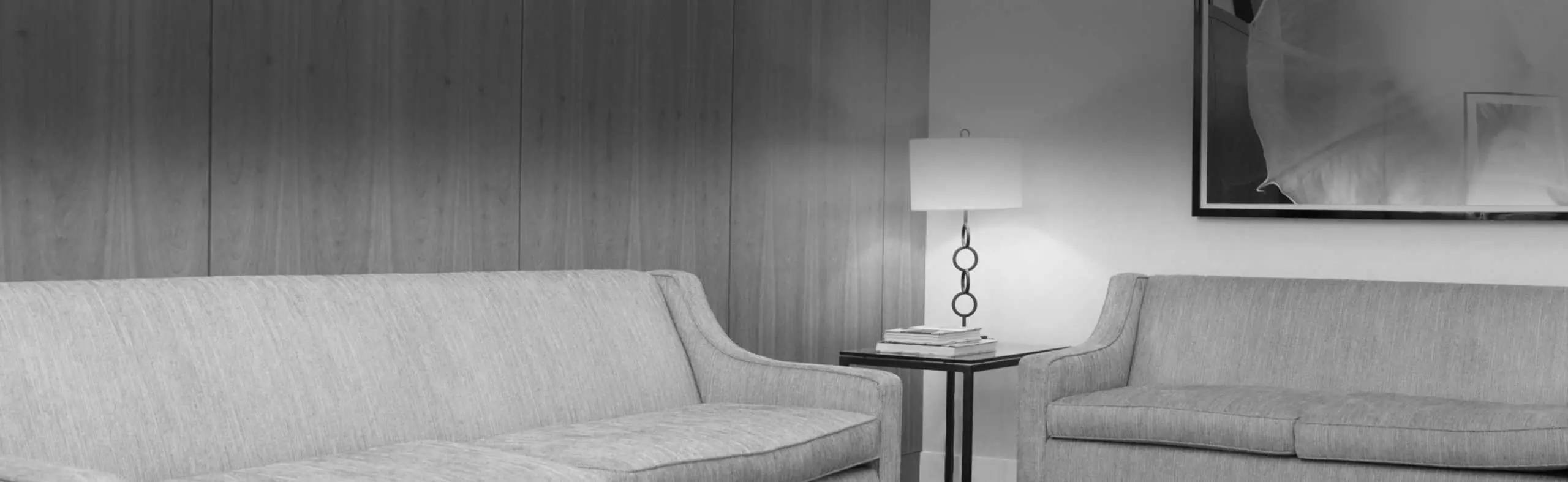 A black and white photo of a living room showcasing our practice.
