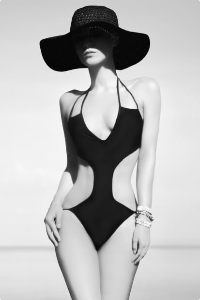 A black and white photo of a woman in a swimsuit.