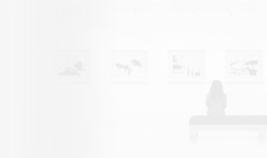 A woman sitting on a bench in an art gallery.