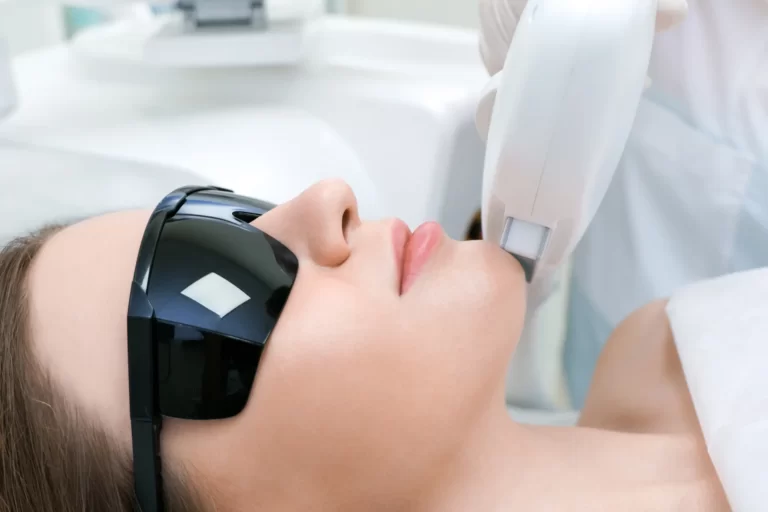 a woman receives laser treatment on her jawline