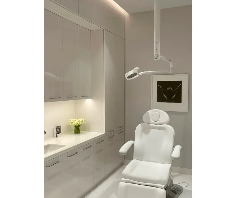 A white dental chair in a white bathroom, providing the perfect setting for abdomen-focused dental procedures.