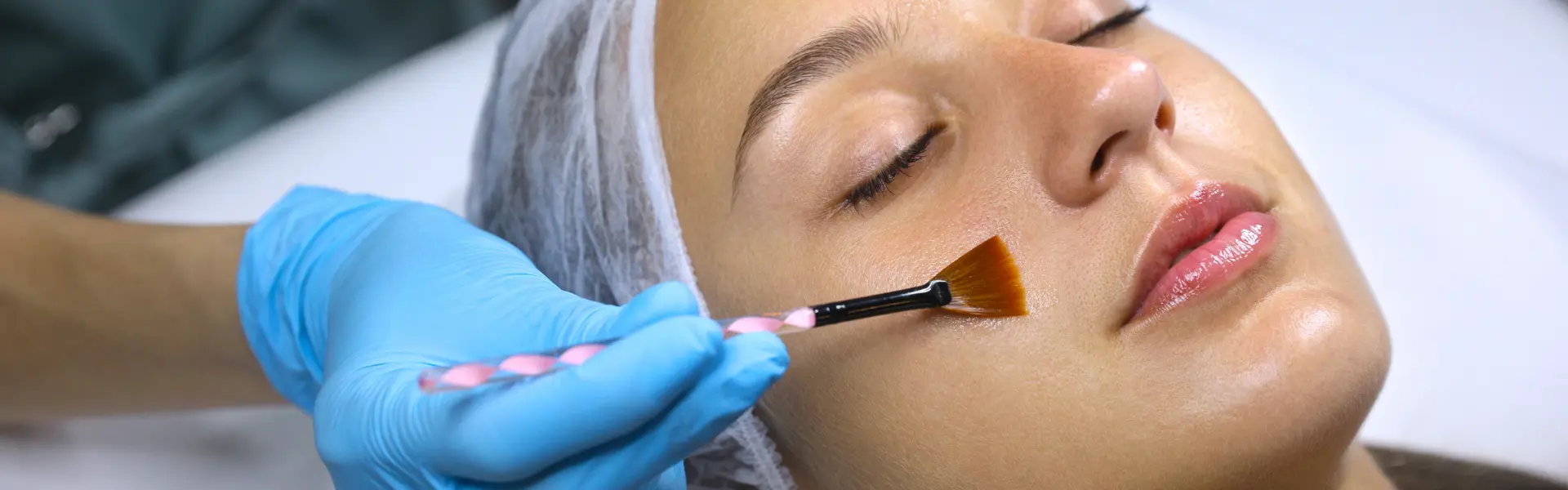 A woman getting a facial treatment at a beauty salon.