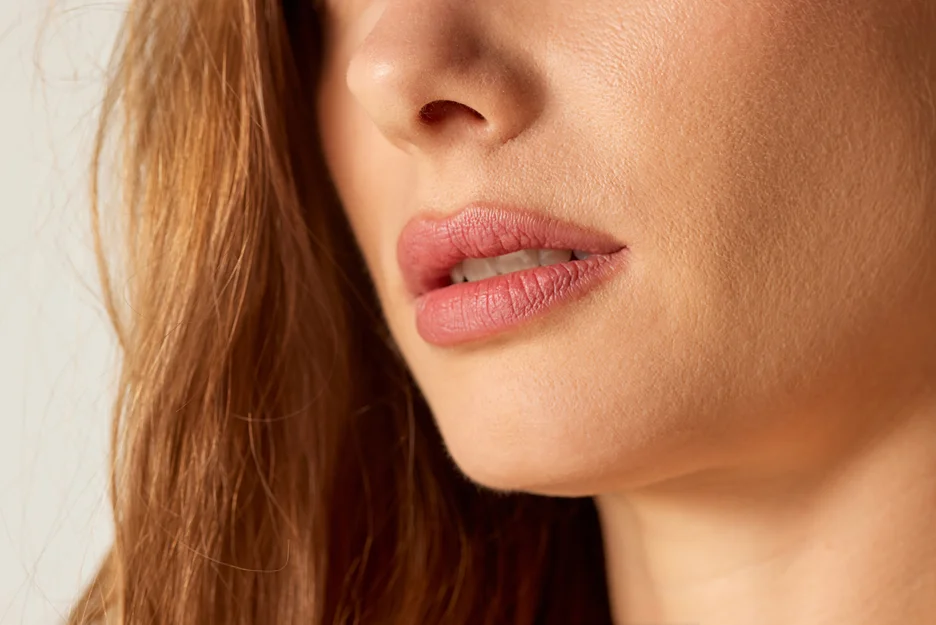 A close up of a woman's face undergoing chin lipo.