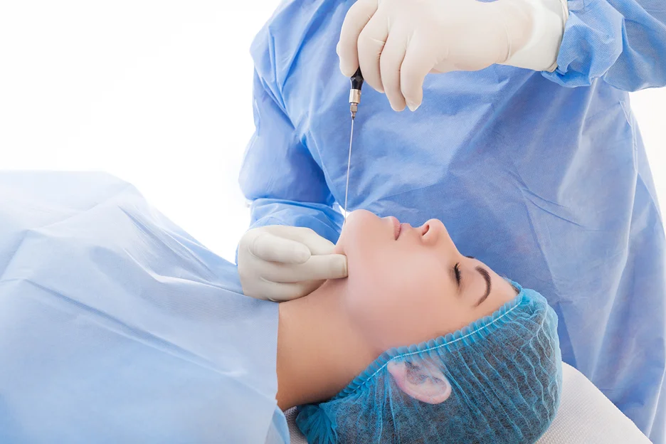 A woman excitedly undergoes a chin and jowl liposuction procedure, aiming to enhance her facial appearance.