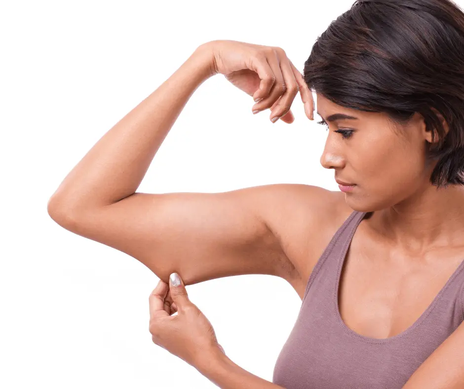 A woman showcasing her strong arm muscles.