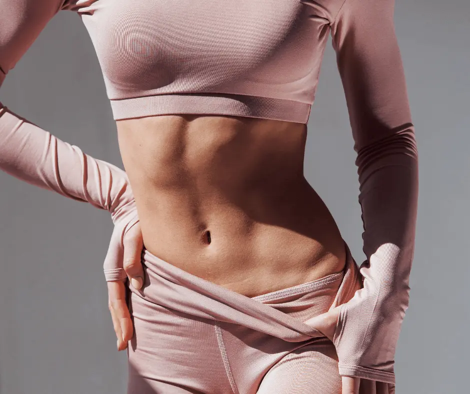 A woman in a pink sports top and leggings striking a pose for a micro fashion shoot.
