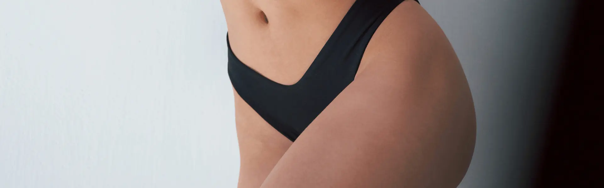 A woman in a black bikini top and bottom.
