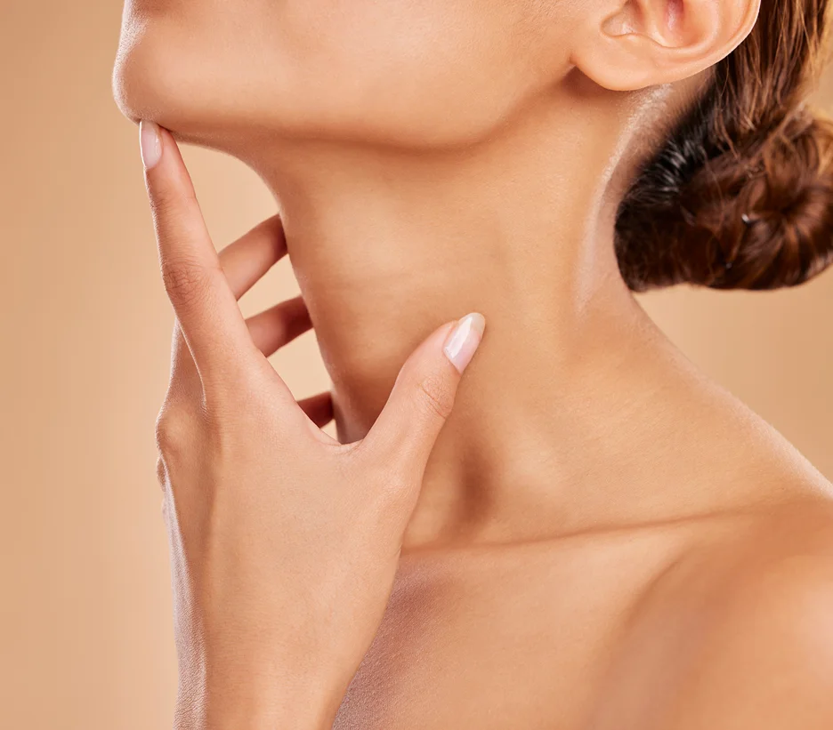 A woman's neck with slightly swollen lymph nodes after chin lipo.