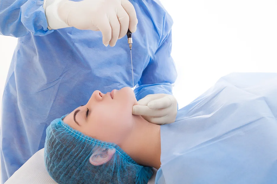 A woman is undergoing a Smart Lipo procedure to enhance her chin.