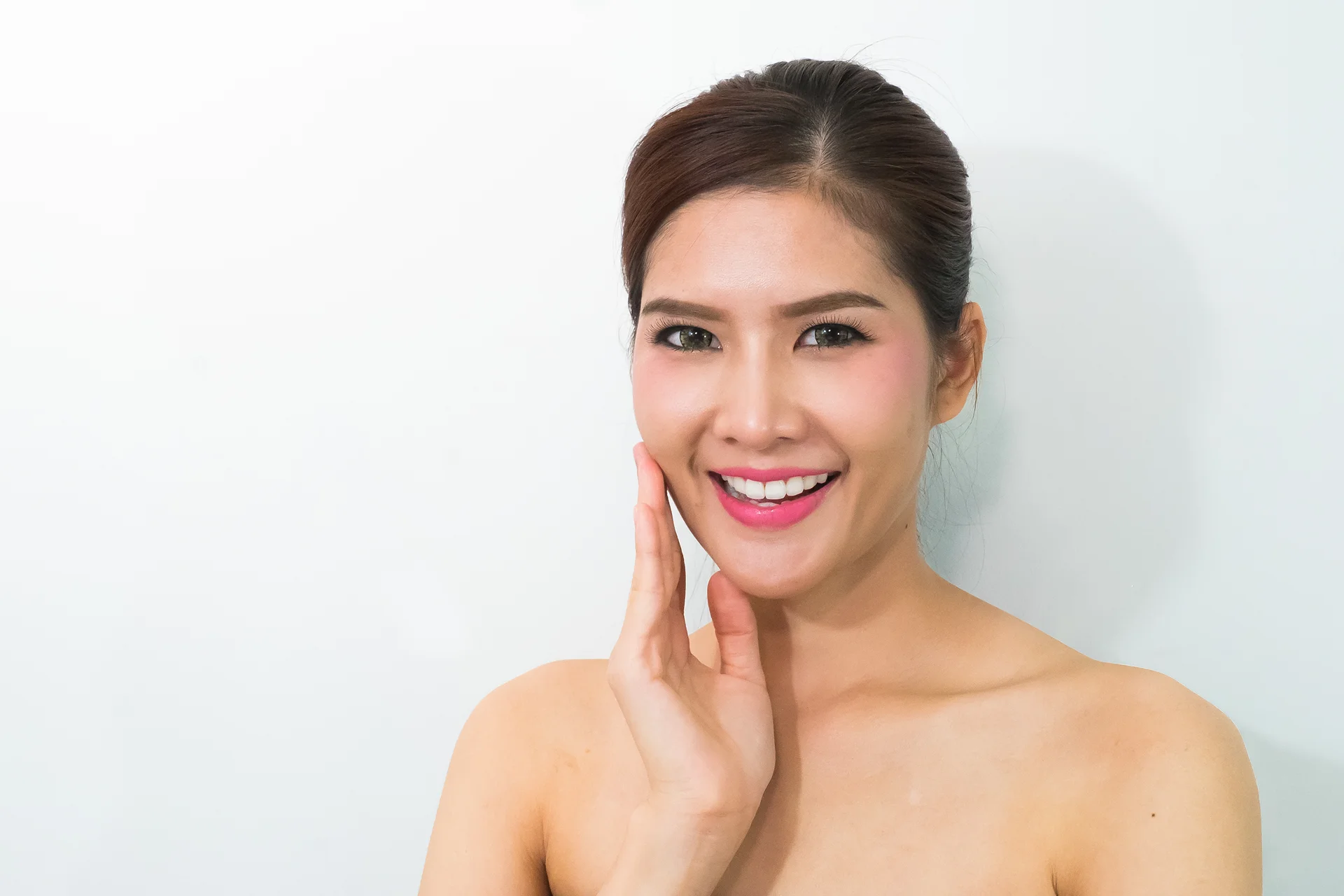 A woman smiling after chin liposuction treatment