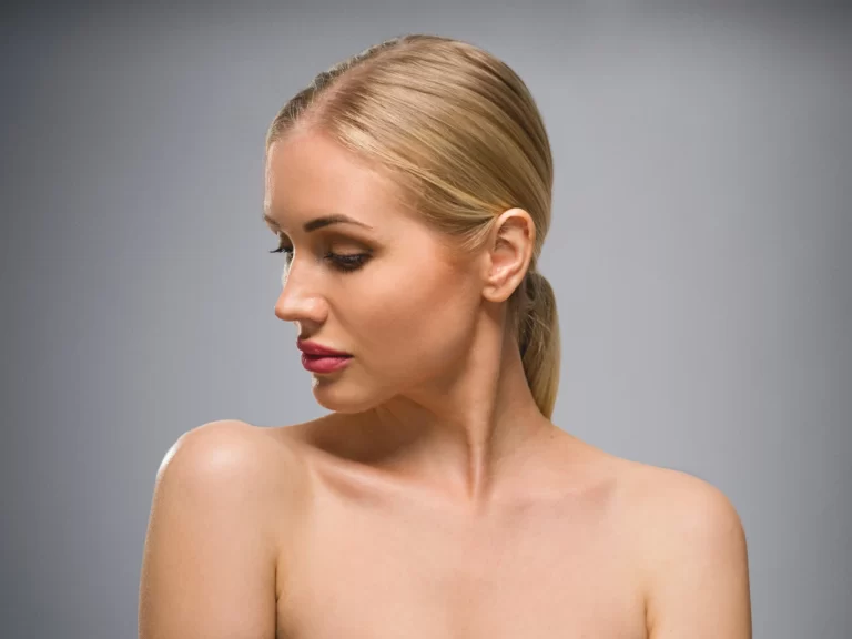 A woman with blonde hair undergoing chin liposuction.