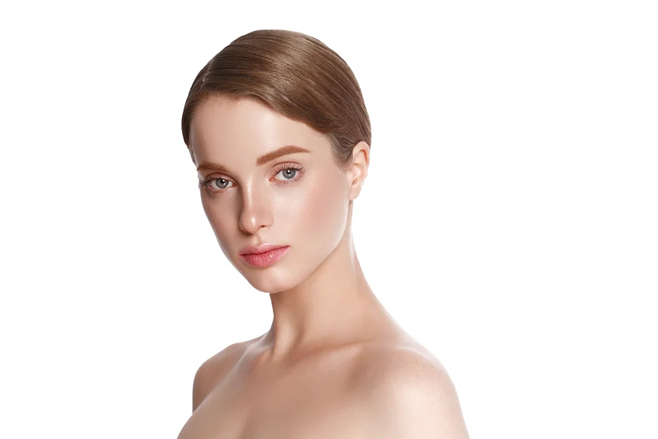 A woman is posing for a photo on a white background, showcasing a flawless appearance after undergoing chin lipo and neck lift procedures.