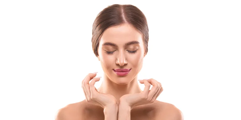 A woman posing with her hands on her chin, after undergoing chin lipo.