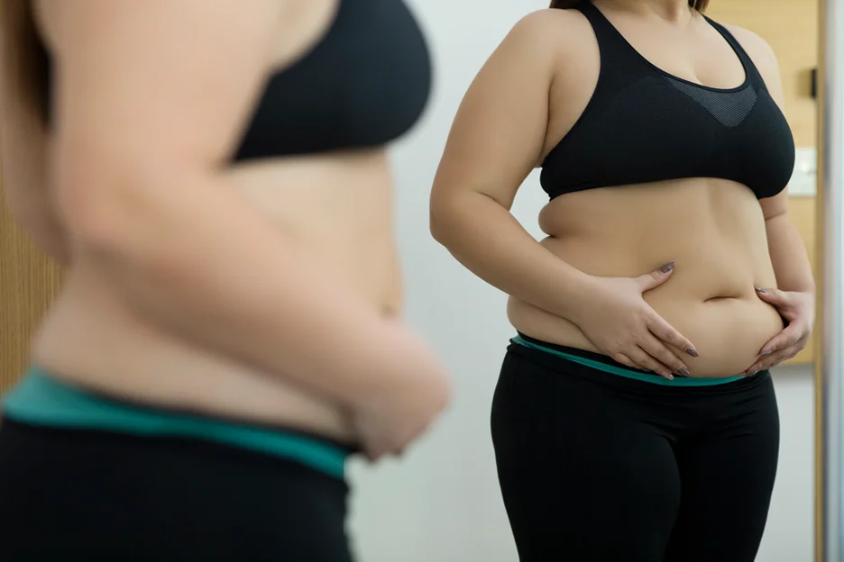 A Woman Touching her Belly Fat