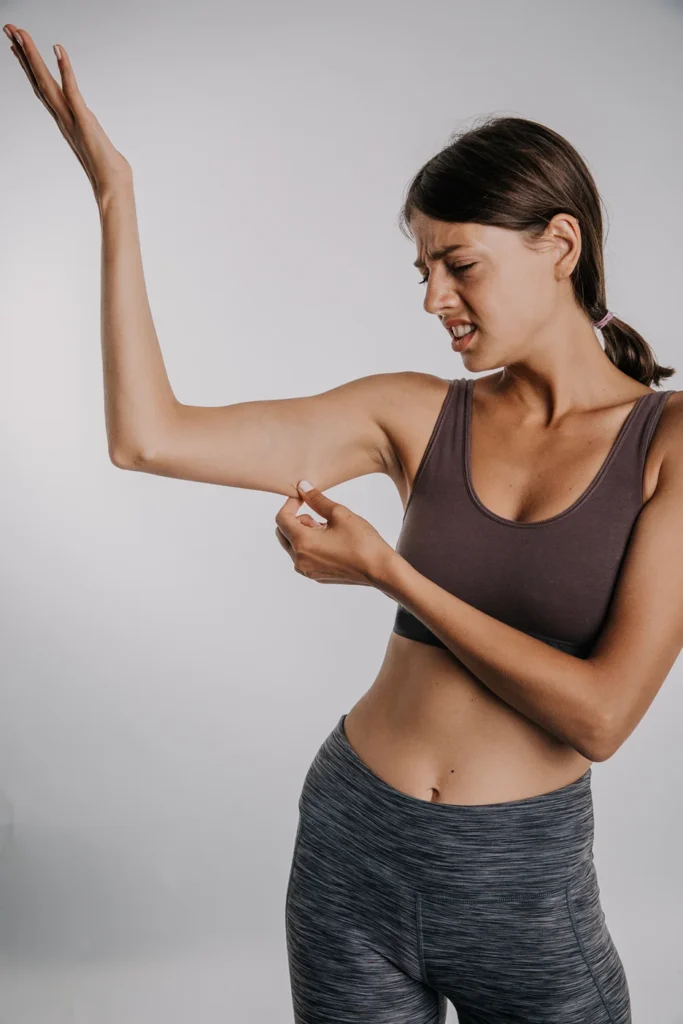 A Woman Pinching Her Skinny Arm